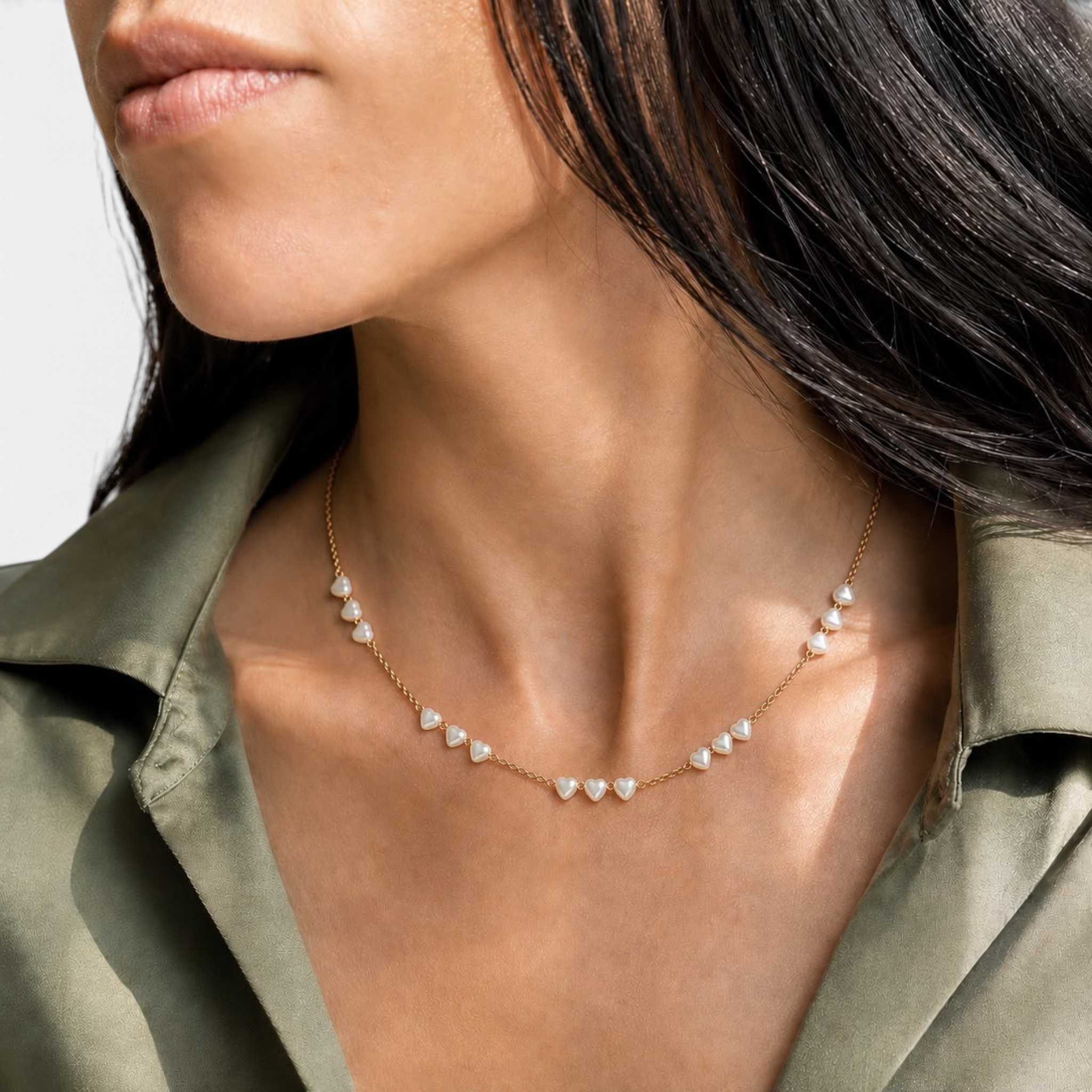 Beach Rose Co. 18K gold filled necklace featuring delicate heart-shaped pearl beads worn on a woman