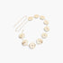 Beach Rose Co. gold metal chain belt featuring circular medallions with intricate embossed designs.