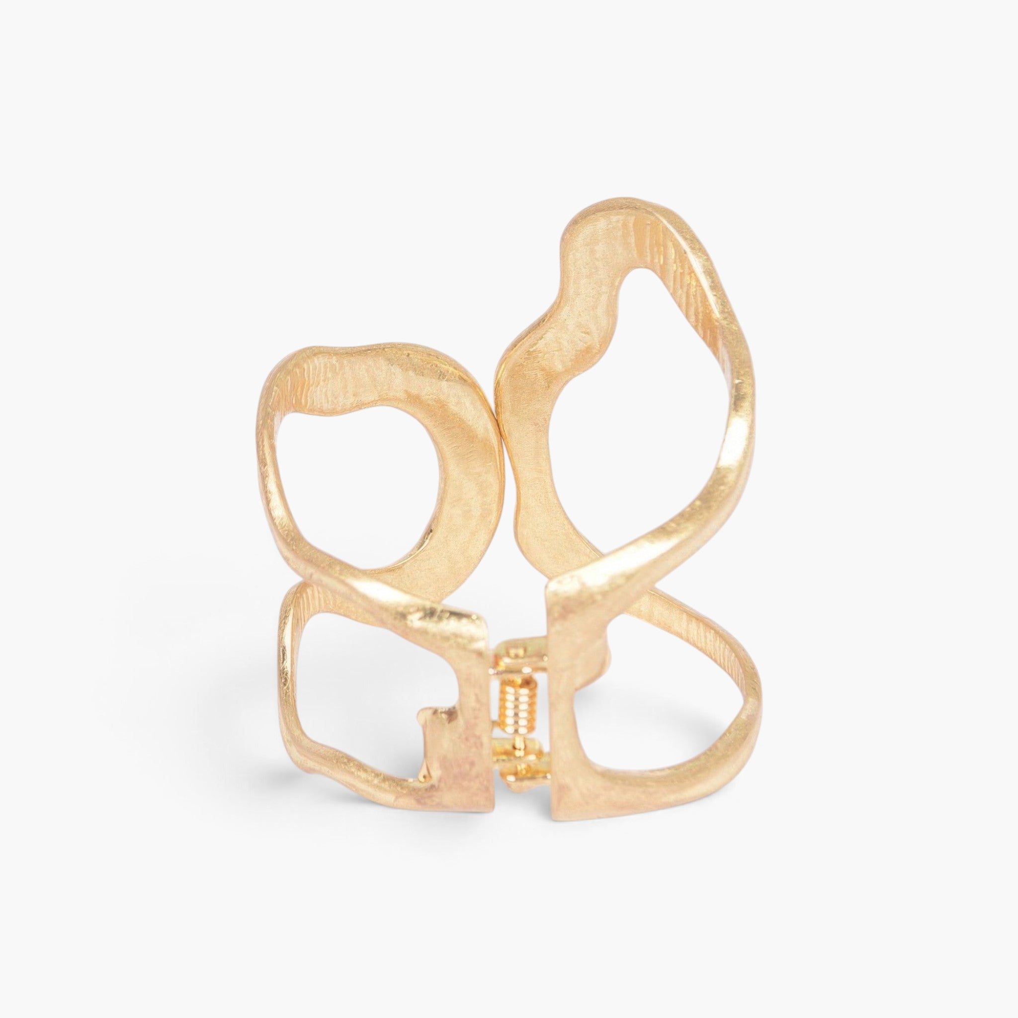 Beach Rose Co. gold cast metal cuff bracelet with an open abstract design and a convenient spring hinge closure.