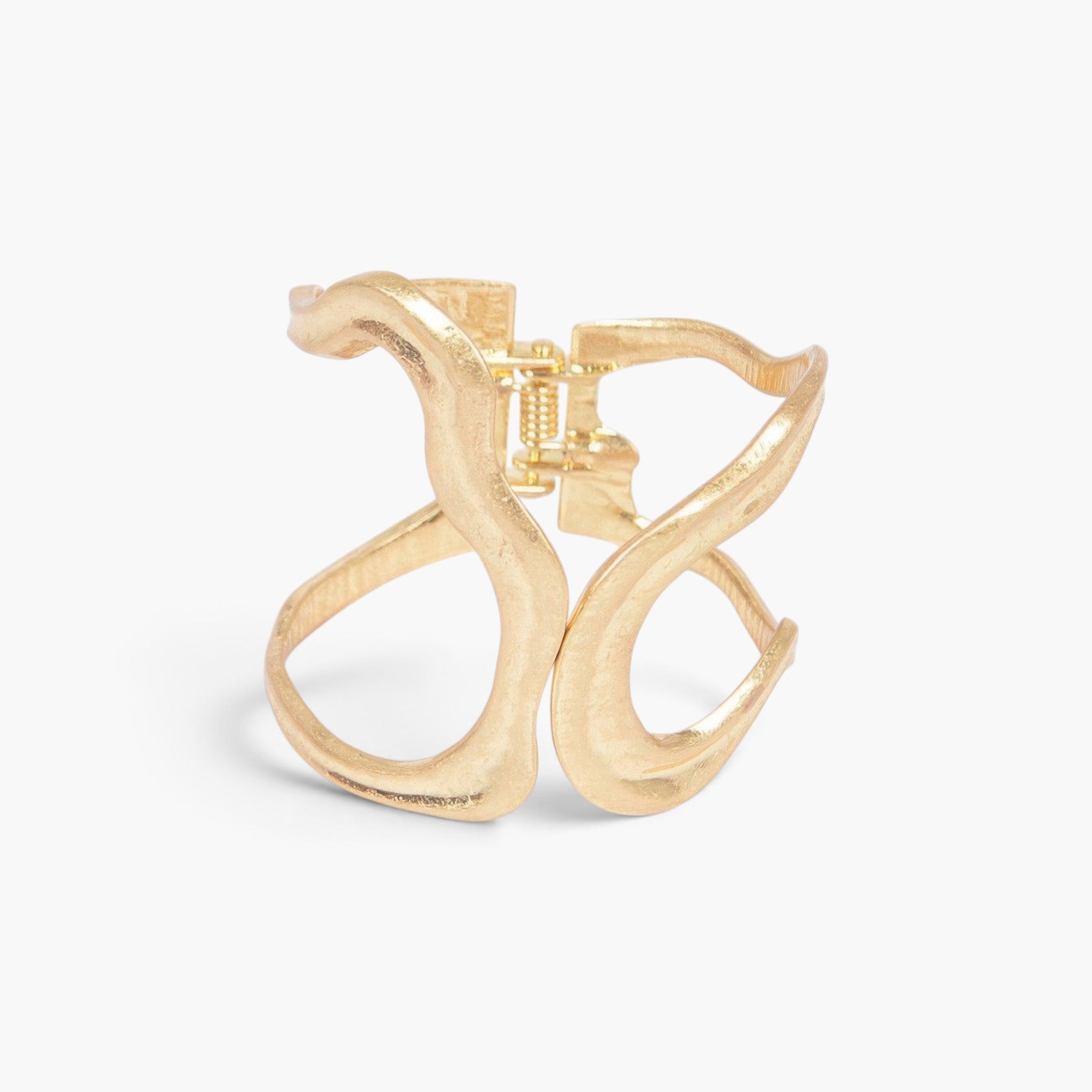 Beach Rose Co. gold cast metal cuff bracelet with a minimalist wavy design and a functional spring hinge closure.