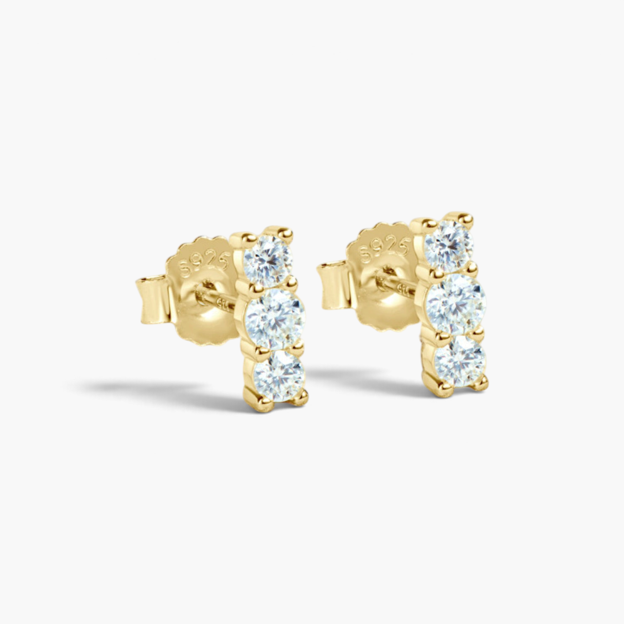 Beach Rose Co. gold-plated sterling silver bar stud earrings featuring three round moissanite stones in prong settings.
