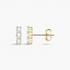 Beach Rose Co. gold-plated sterling silver bar stud earrings featuring three round moissanite stones in prong settings.