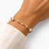 Beach Rose Co. 18K gold filled bracelet featuring pearl-look beads and slender bar links on a delicate gold chain.