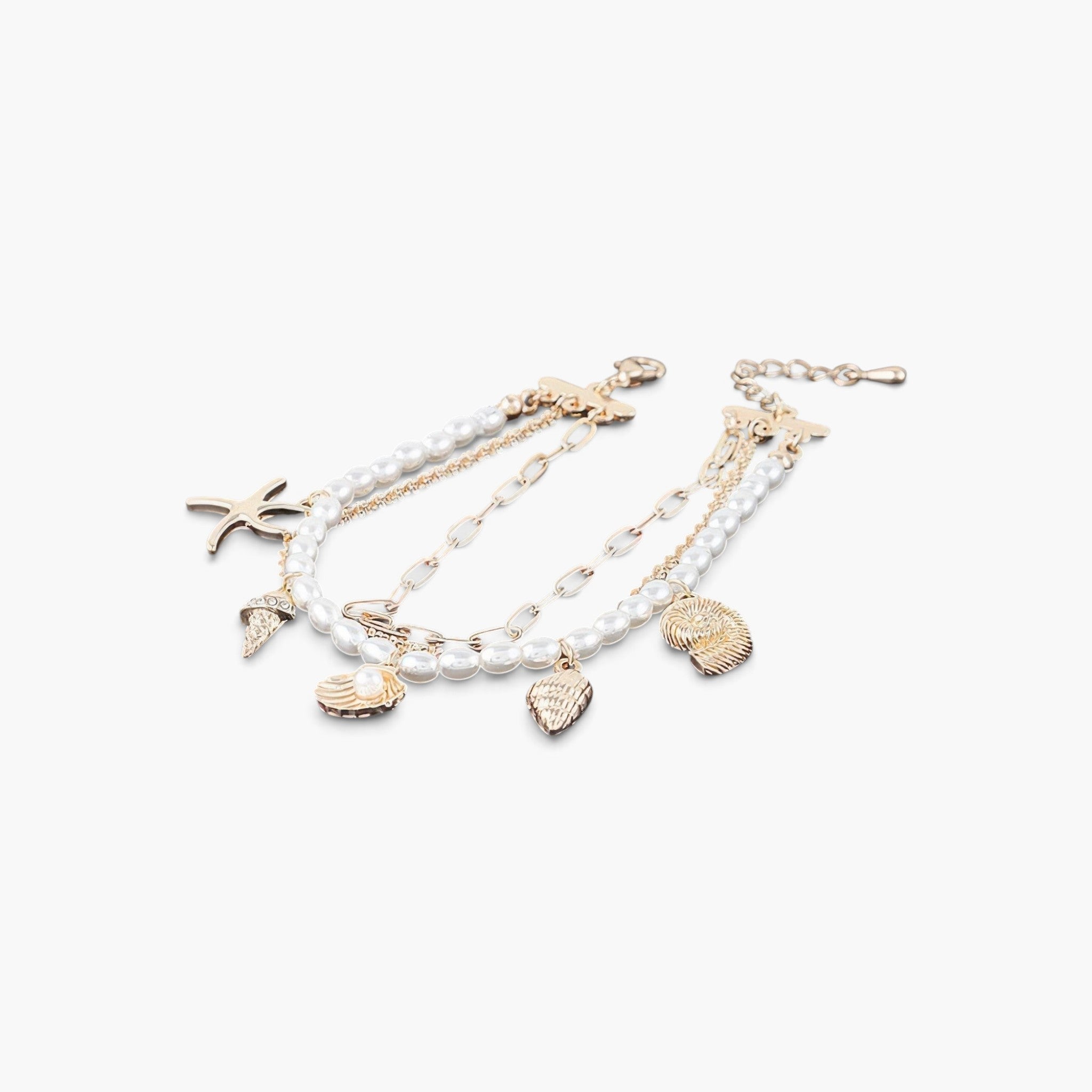 Beach Rose Co. layered gold chain bracelet featuring pearl-like beads, starfish, and seashell charms.