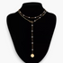 Beach Rose Co. 18K gold-plated lariat necklace featuring white synthetic pearls, mixed chains, and a round disc charm.