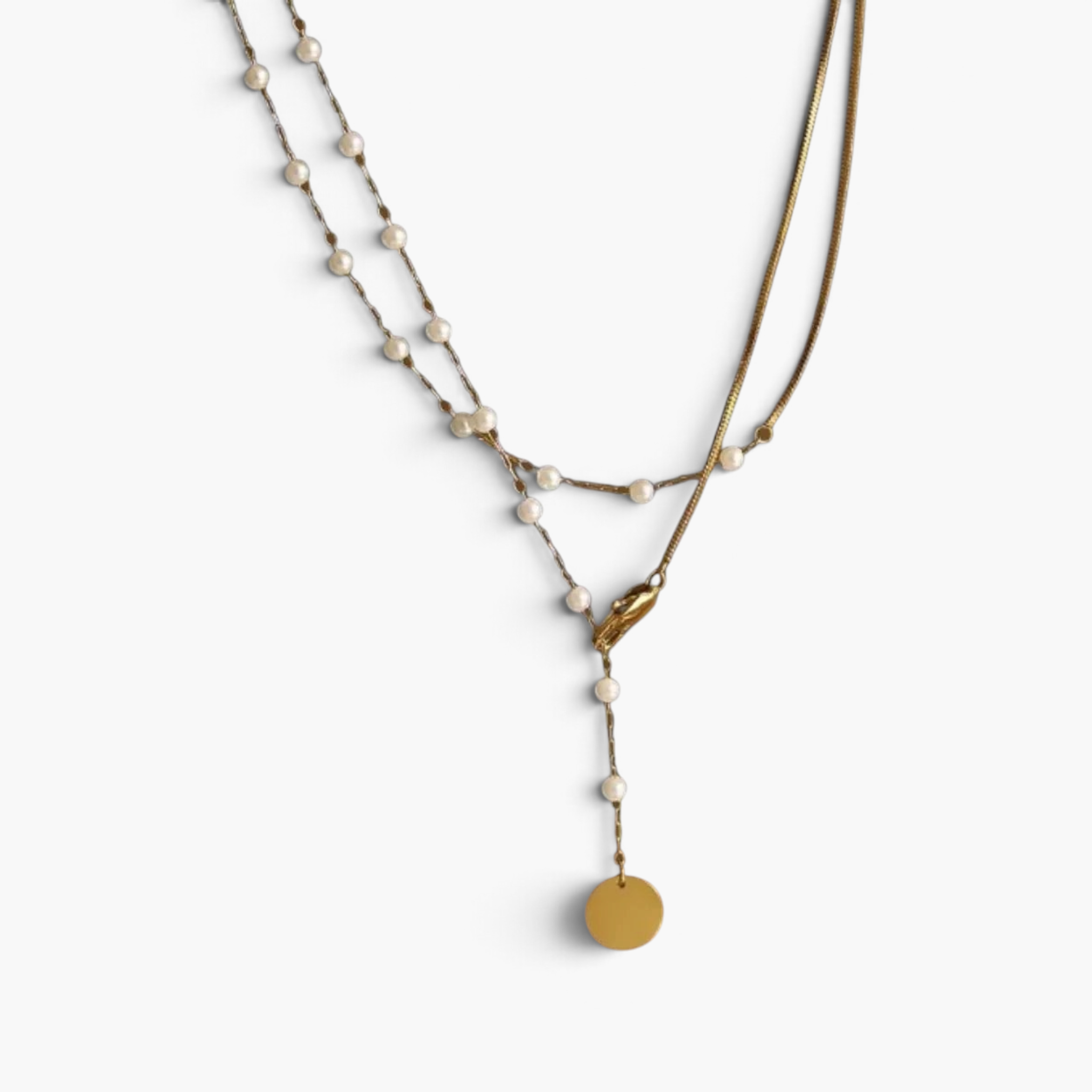 Beach Rose Co. 18K gold-plated lariat necklace featuring white synthetic pearls, mixed chains, and a round disc charm.