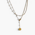 Beach Rose Co. 18K gold-plated lariat necklace featuring white synthetic pearls, mixed chains, and a round disc charm.