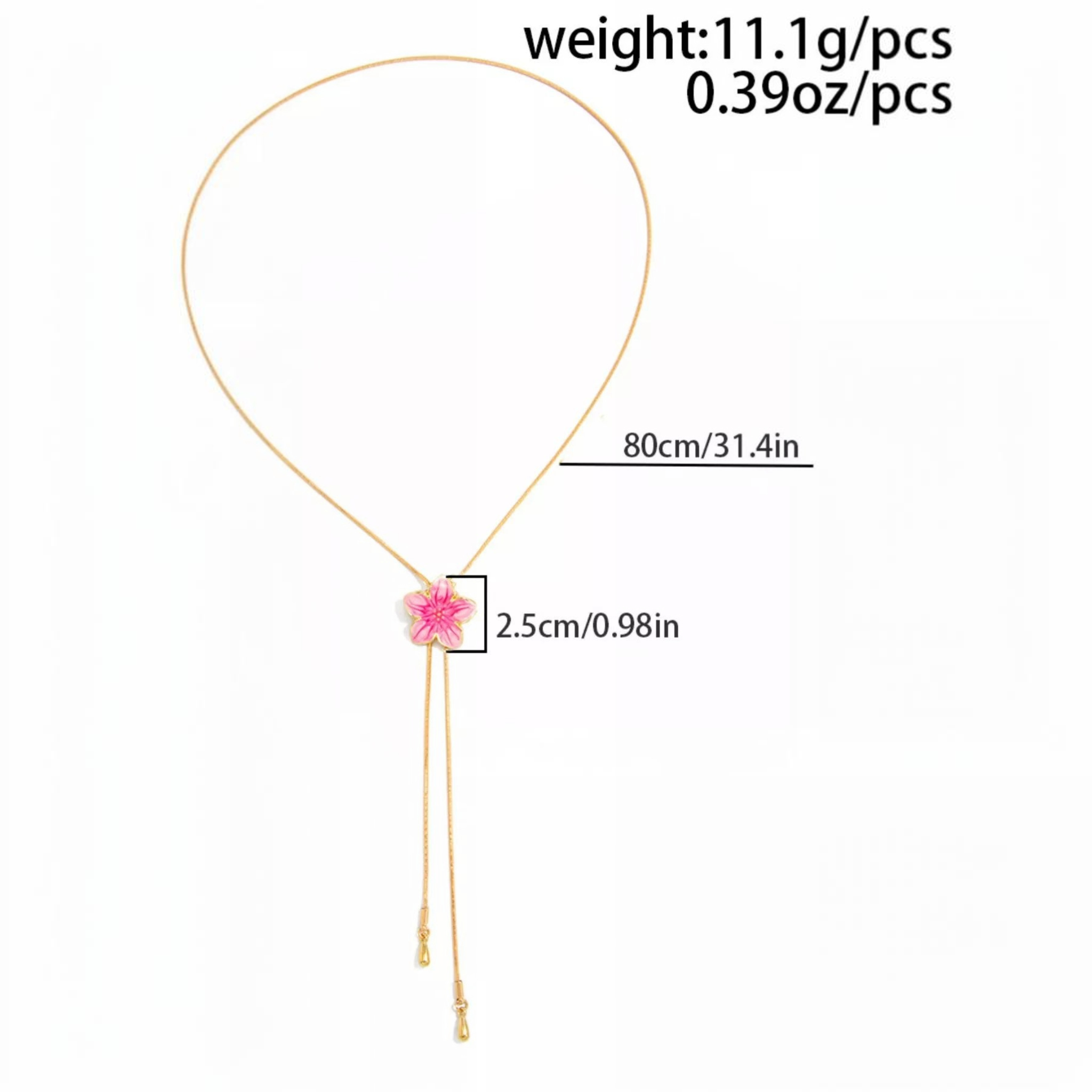 Beach Rose Co. 18K gold-plated lariat necklace featuring a pink resin flower and cascading teardrop chain ends.