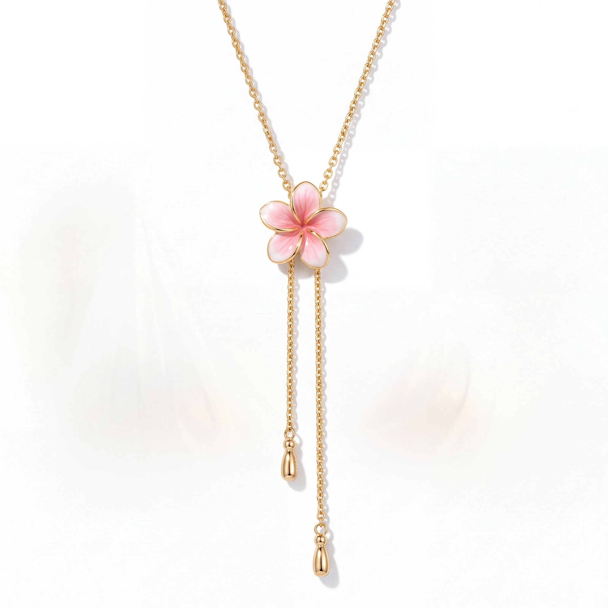 Beach Rose Co. 18K gold-plated lariat necklace featuring a pink resin flower and two cascading teardrop chain drops.