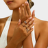 Beach Rose Co. 18K gold-plated five-piece ring set featuring chain-link, stone-accented, and crossover designs.