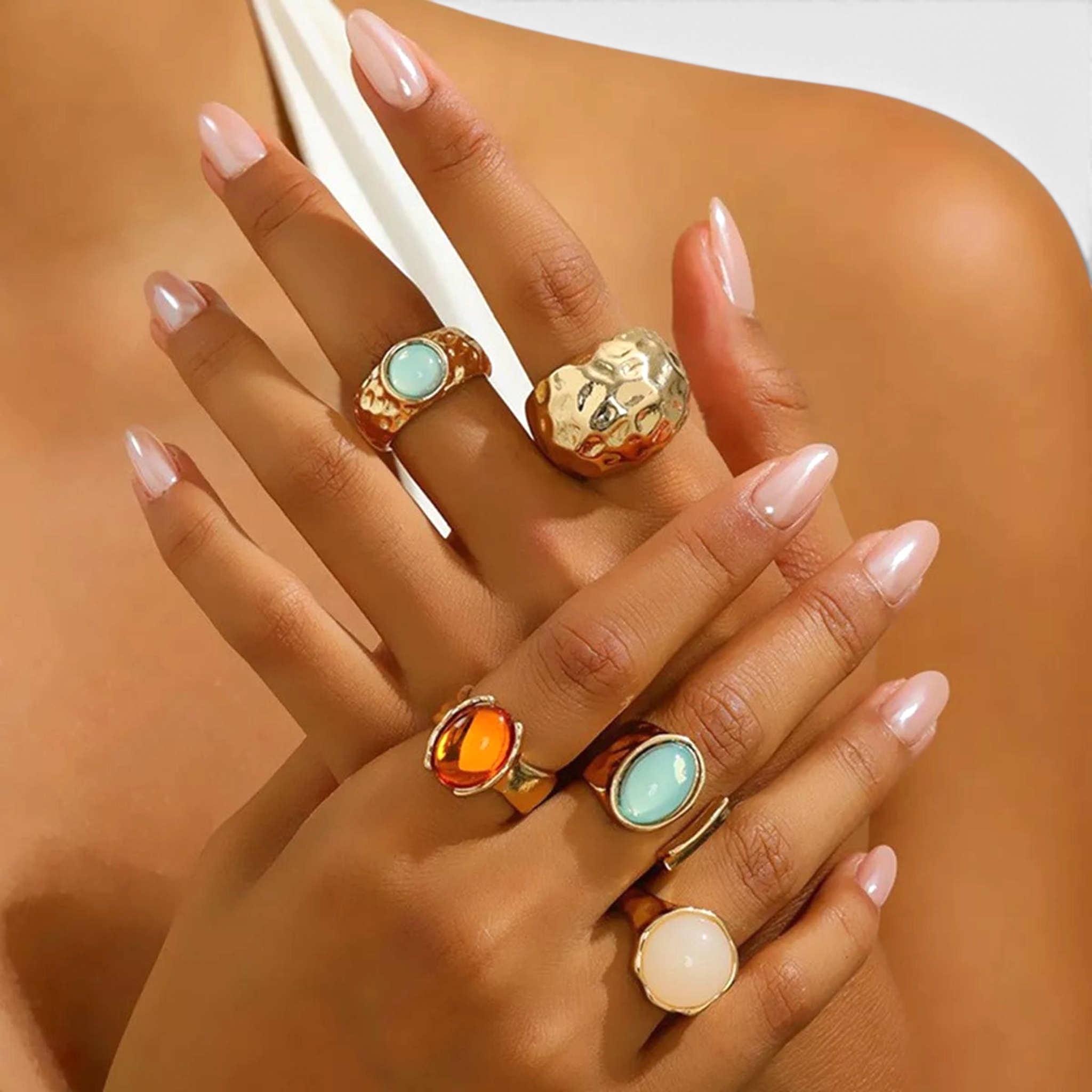 Beach Rose Co. five-piece ring set featuring 18K gold-plated bands with aqua, amber, and cream resin accents.