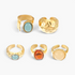 Beach Rose Co. five-piece ring set featuring 18K gold-plated bands with aqua, amber, and cream resin accents.