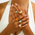 Beach Rose Co. 18K gold-plated ring set featuring aqua, amber, and cream resin stones and hammered metal textures.