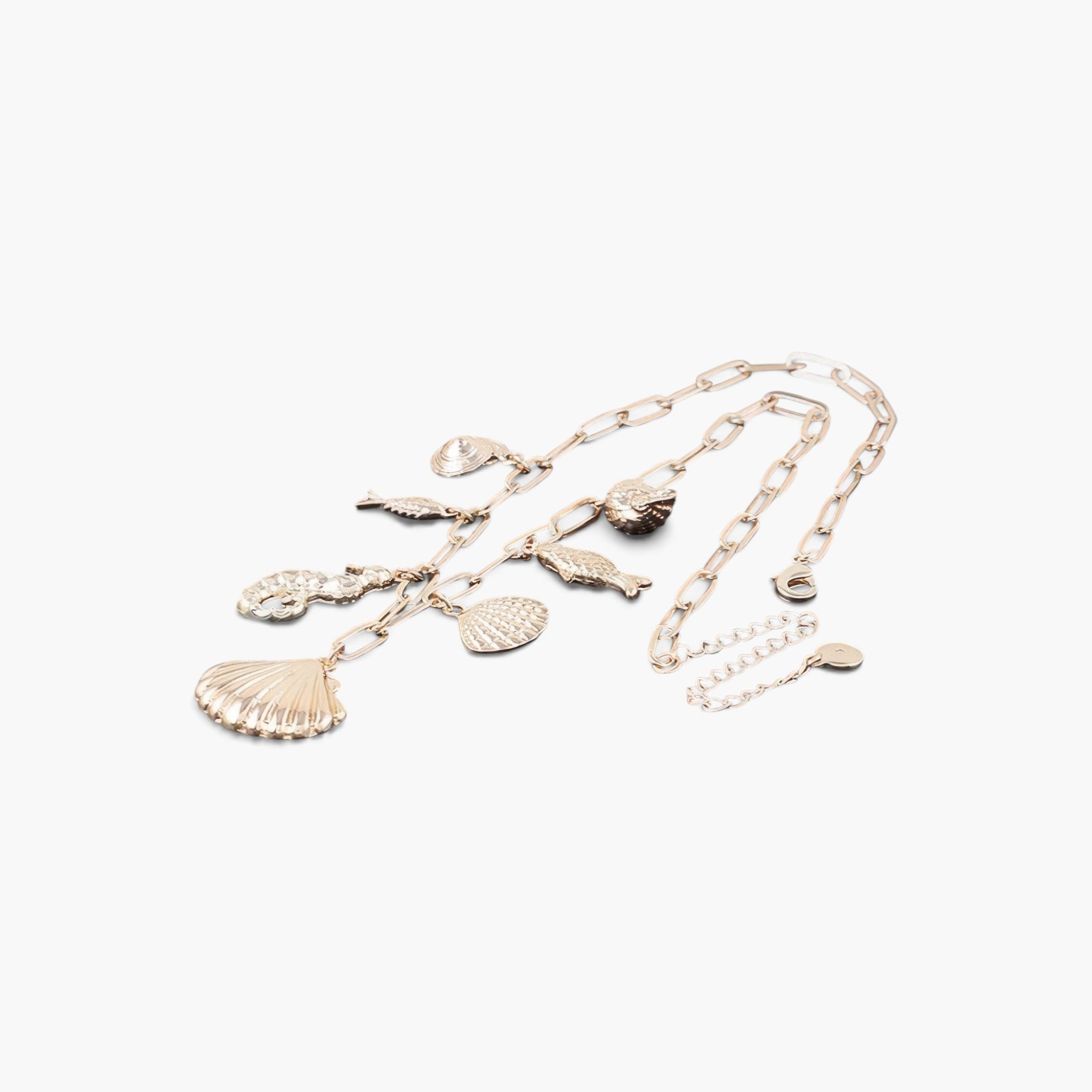 Beach Rose Co. gold chain necklace featuring delicate sea-themed charms including seashells and a seahorse