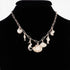 Beach Rose Co. gold chain necklace featuring various ocean-themed charms like a seahorse, seashells, and fish.
