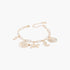 Beach Rose Co. gold chain bracelet featuring various sea creature charms like a starfish, seashell, and seahorse.