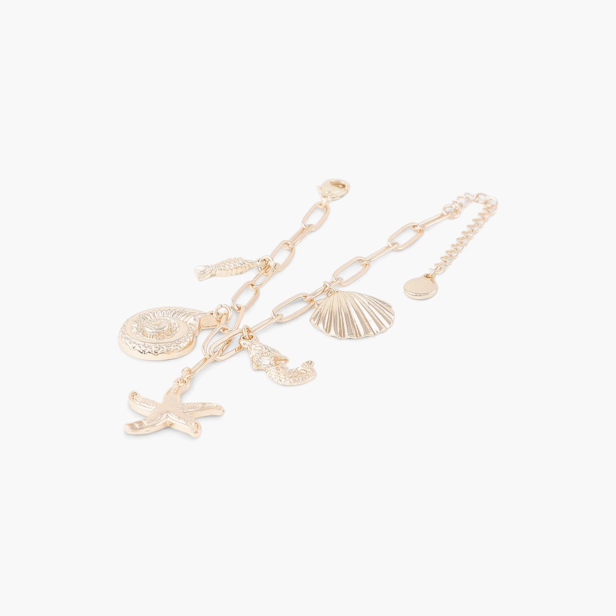 Beach Rose Co. gold chain bracelet featuring dangling starfish, seashell, and seahorse charms for a nautical look.