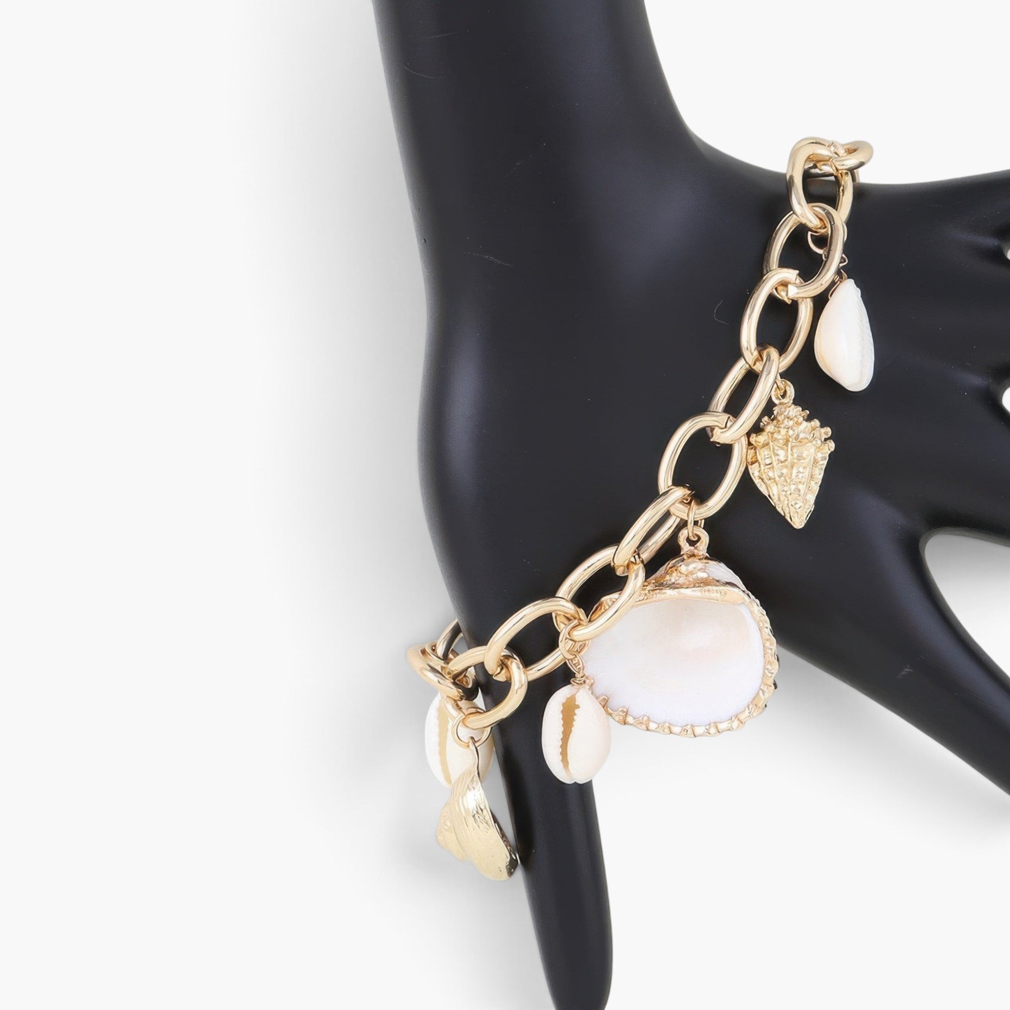 Beach Rose Co. gold chain bracelet featuring delicate cream seashell charms for a coastal summer look.