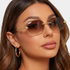 Beach Rose Co. rimless geometric sunglasses with brown gradient lenses and gold sculpted snake temple details.