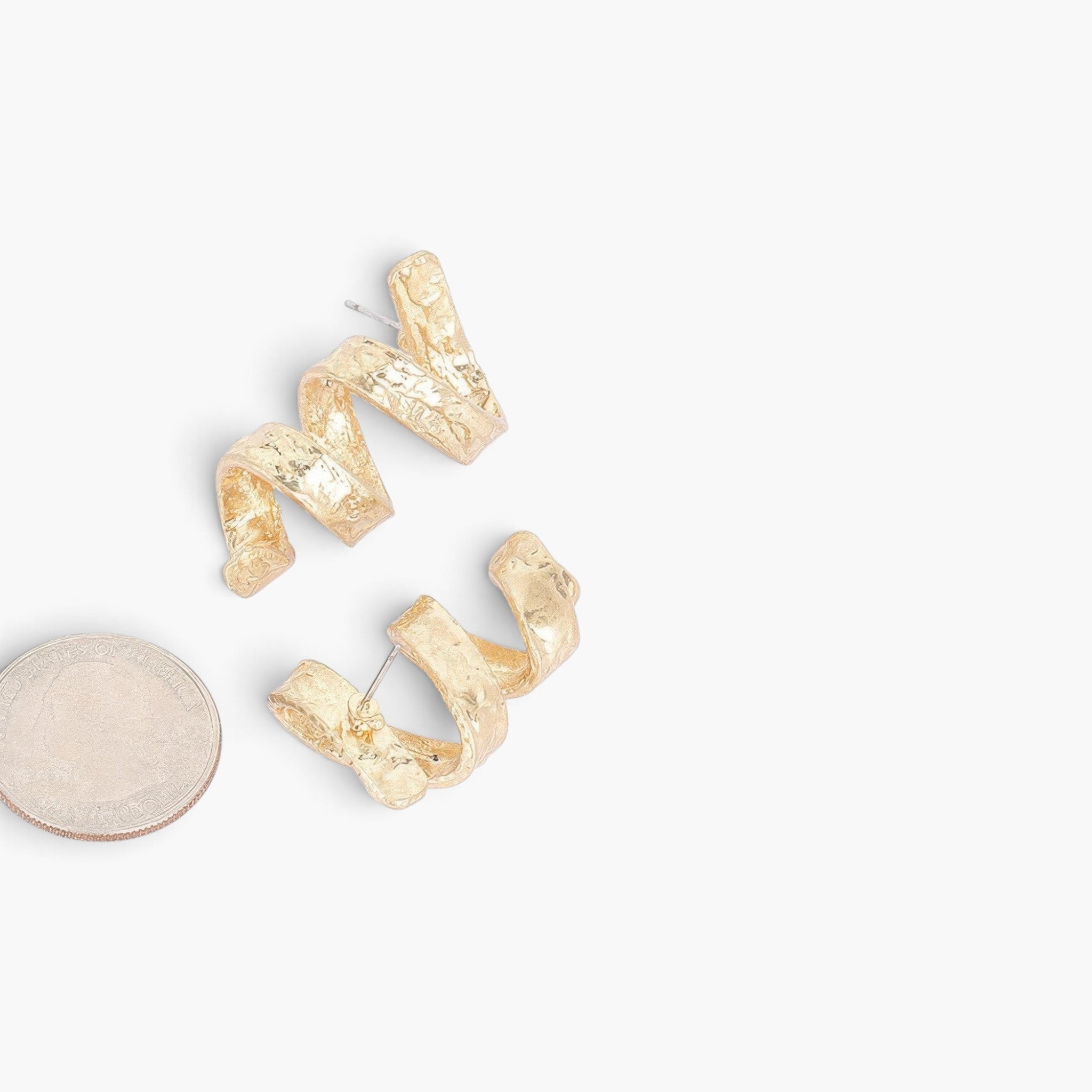 Beach Rose Co. gold-plated metal spiral earrings with a textured finish, shown next to a US quarter for scale.