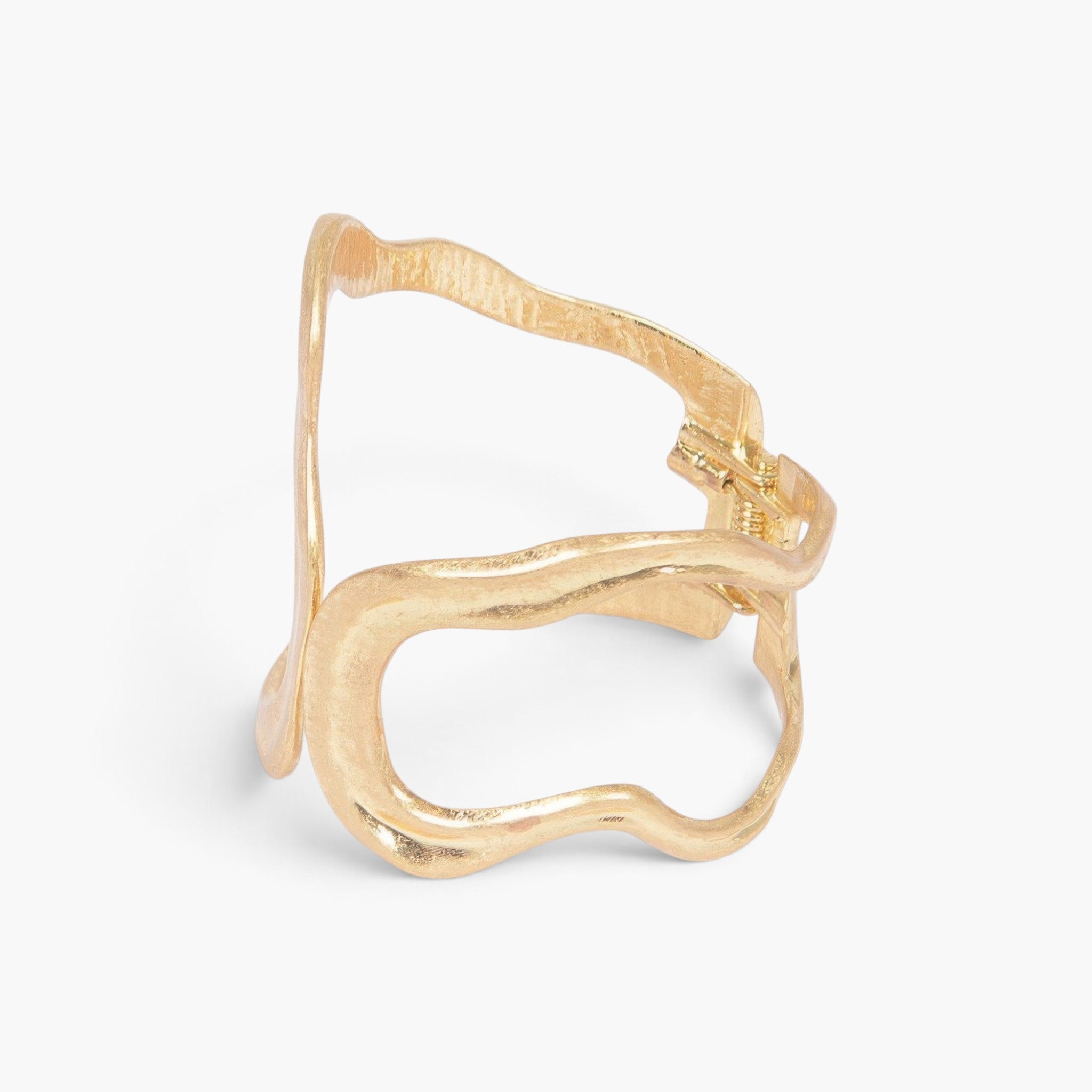 Beach Rose Co. gold cast metal cuff bracelet with a wavy minimalist design and a functional spring hinge closure.