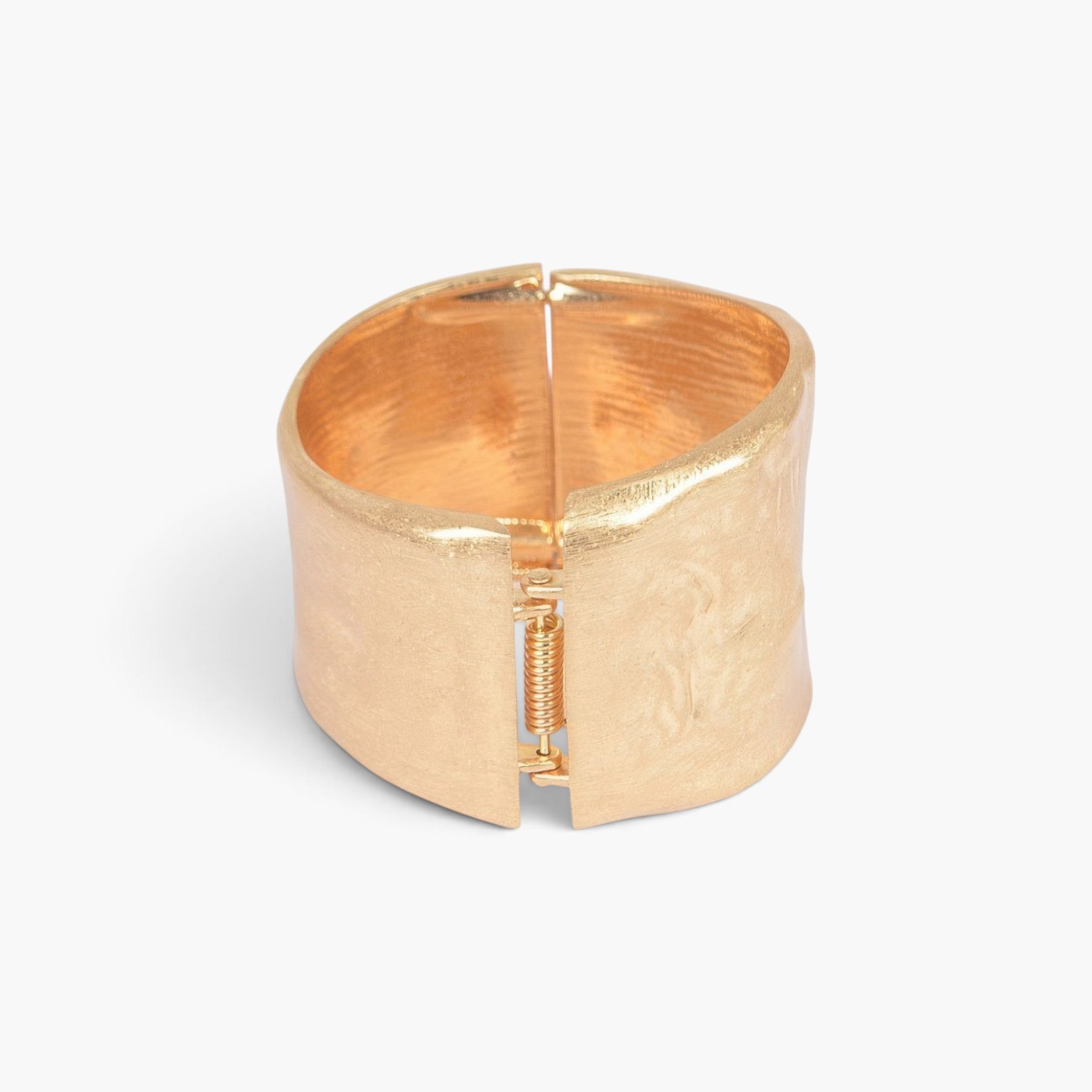 Beach Rose Co. gold cast metal cuff bracelet with a textured finish and a functional spring hinge closure.