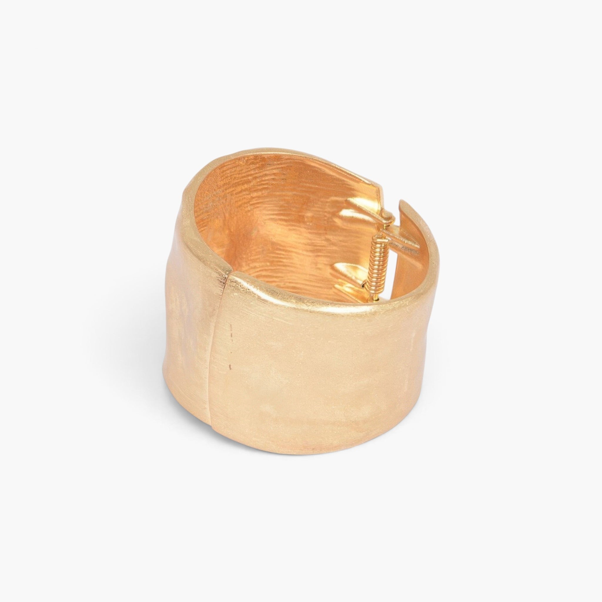 Beach Rose Co. gold cast metal cuff bracelet with a convenient spring hinge closure for an adjustable fit.