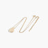 Beach Rose Co. gold teardrop chain necklace with a minimalist disc charm on a delicate chain.