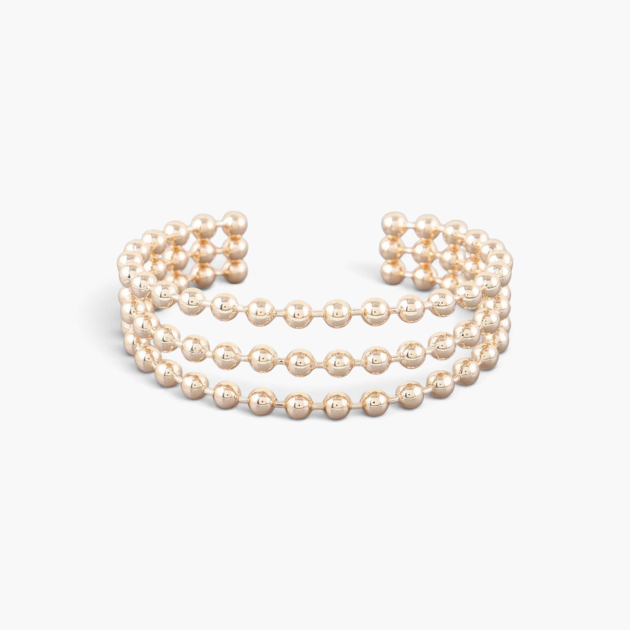 Beach Rose Co. wide gold cuff bracelet featuring three rows of polished spherical beads in an adjustable open design.