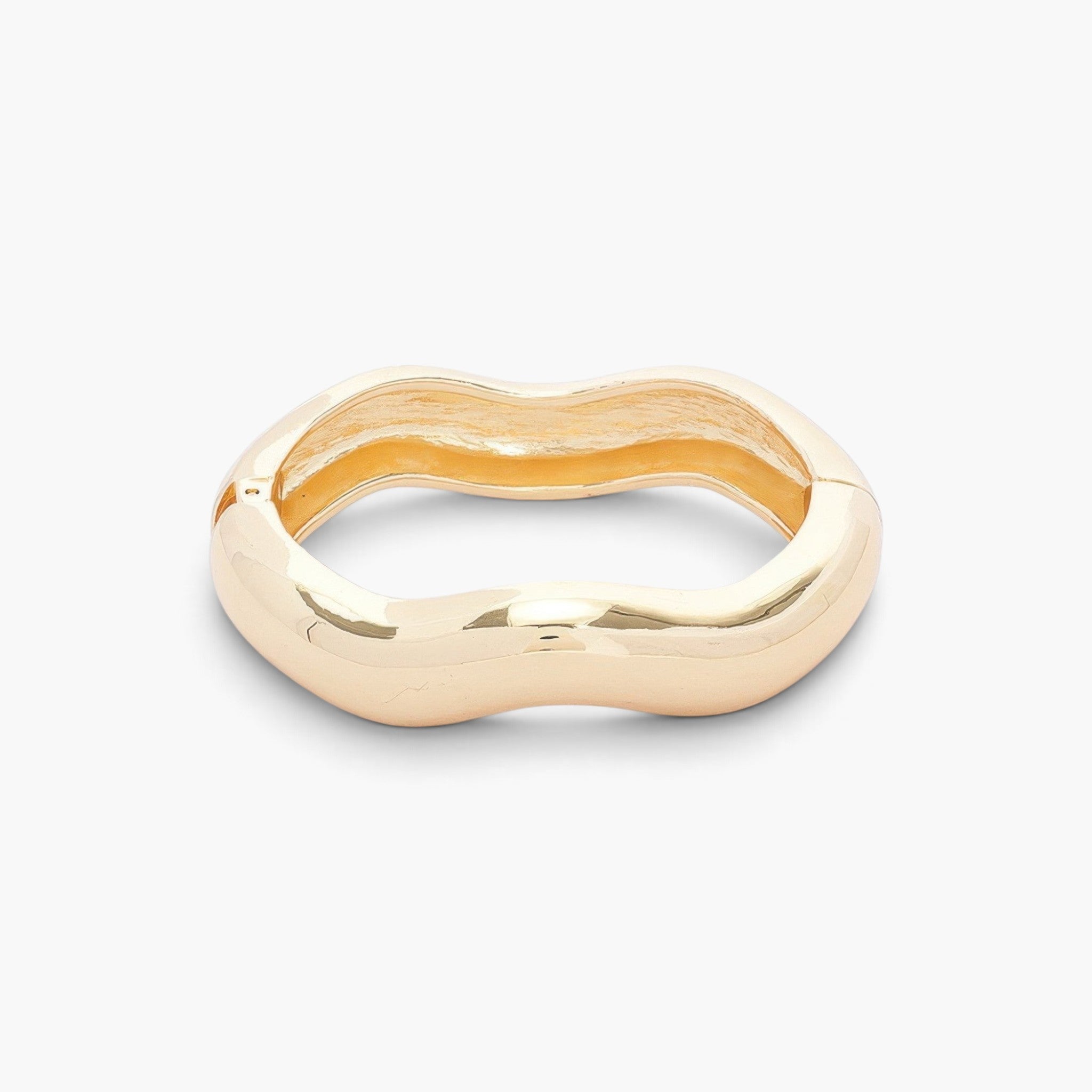 Beach Rose Co. gold metal spring hinge bangle with a smooth, polished wavy design for a modern minimalist look.