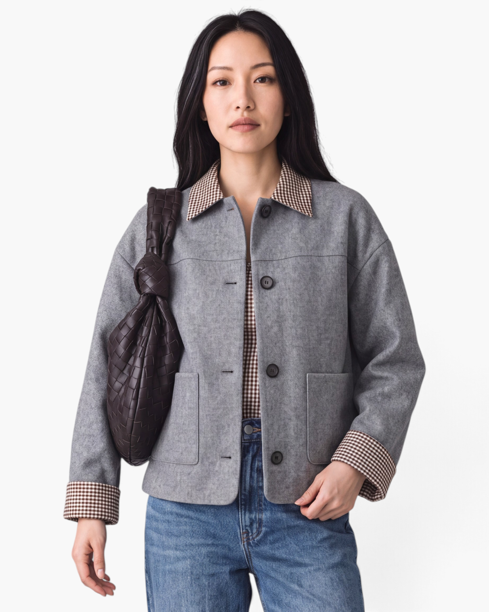 Beach Rose Co. gray button-front jacket with brown and cream gingham collar and cuffs worn by a model with a bag.