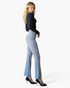 Beach Rose Co. gray plaid high-rise flare pants worn by a model with a black long-sleeve top and black heels.