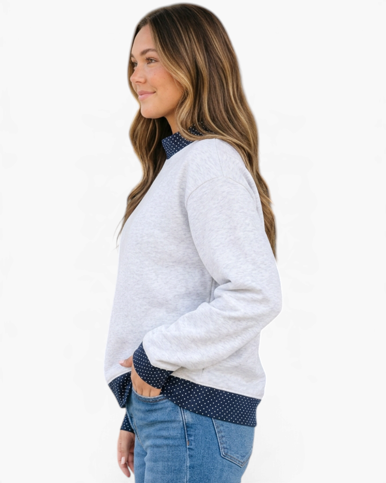 Beach Rose Co. light gray mock neck sweatshirt with navy polka dot trim on a model, side profile view.
