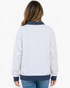 Beach Rose Co. light gray mock neck sweatshirt with navy polka dot trim on cuffs and hem, back view on a model.