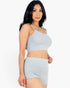 Beach Rose Co. model wearing a light gray ribbed cami crop top and matching ruched shorts set against a white background