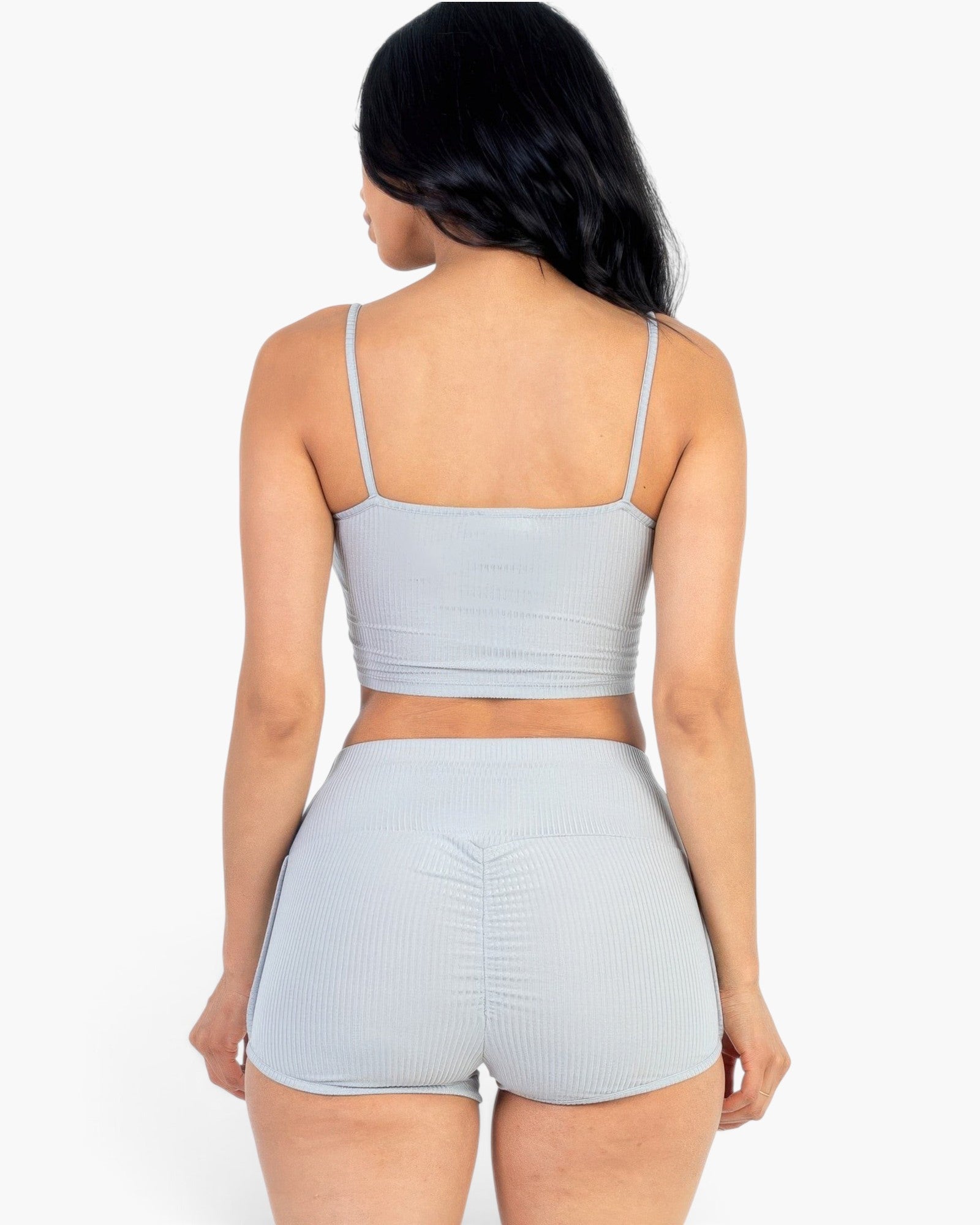 Beach Rose Co. gray ribbed cami crop top and ruched shorts set viewed from the back on a model