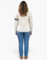 Beach Rose Co. light gray long sleeve cotton top with navy sleeve stripes worn by a woman with wavy hair from behind