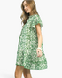 Beach Rose Co. green and cream floral mini dress with flutter sleeves, ruffled neckline, and flounced hem on model.