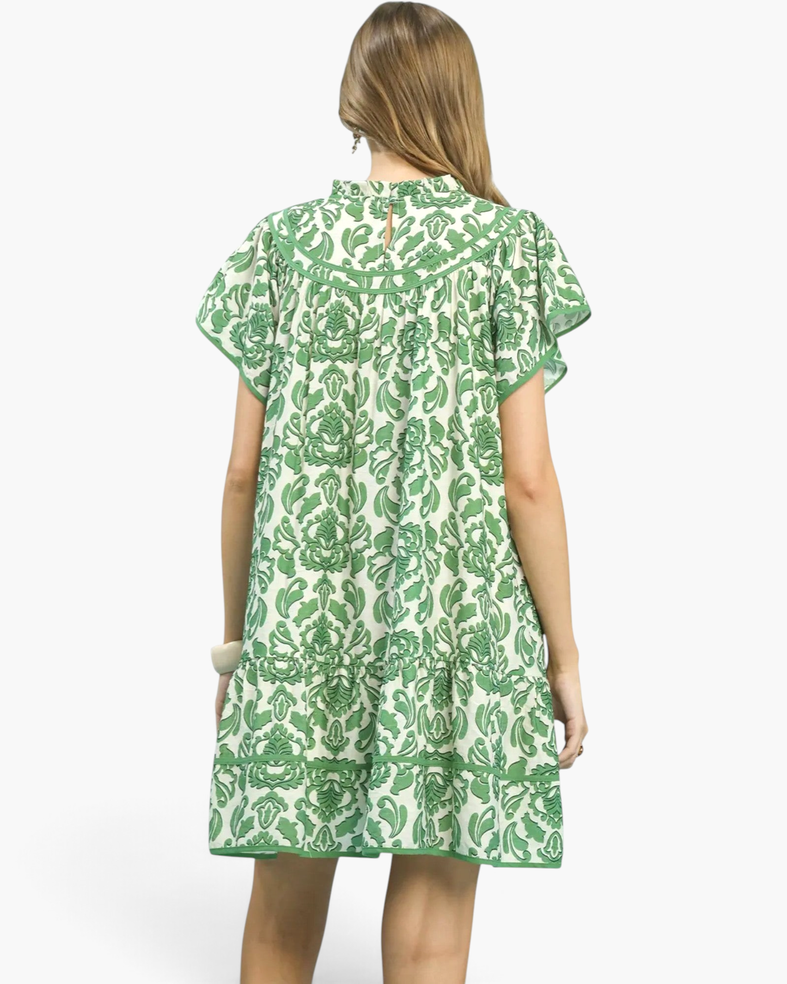 Beach Rose Co. green and cream floral mini dress with flutter sleeves, ruffled neckline, and flounced hem, back view.