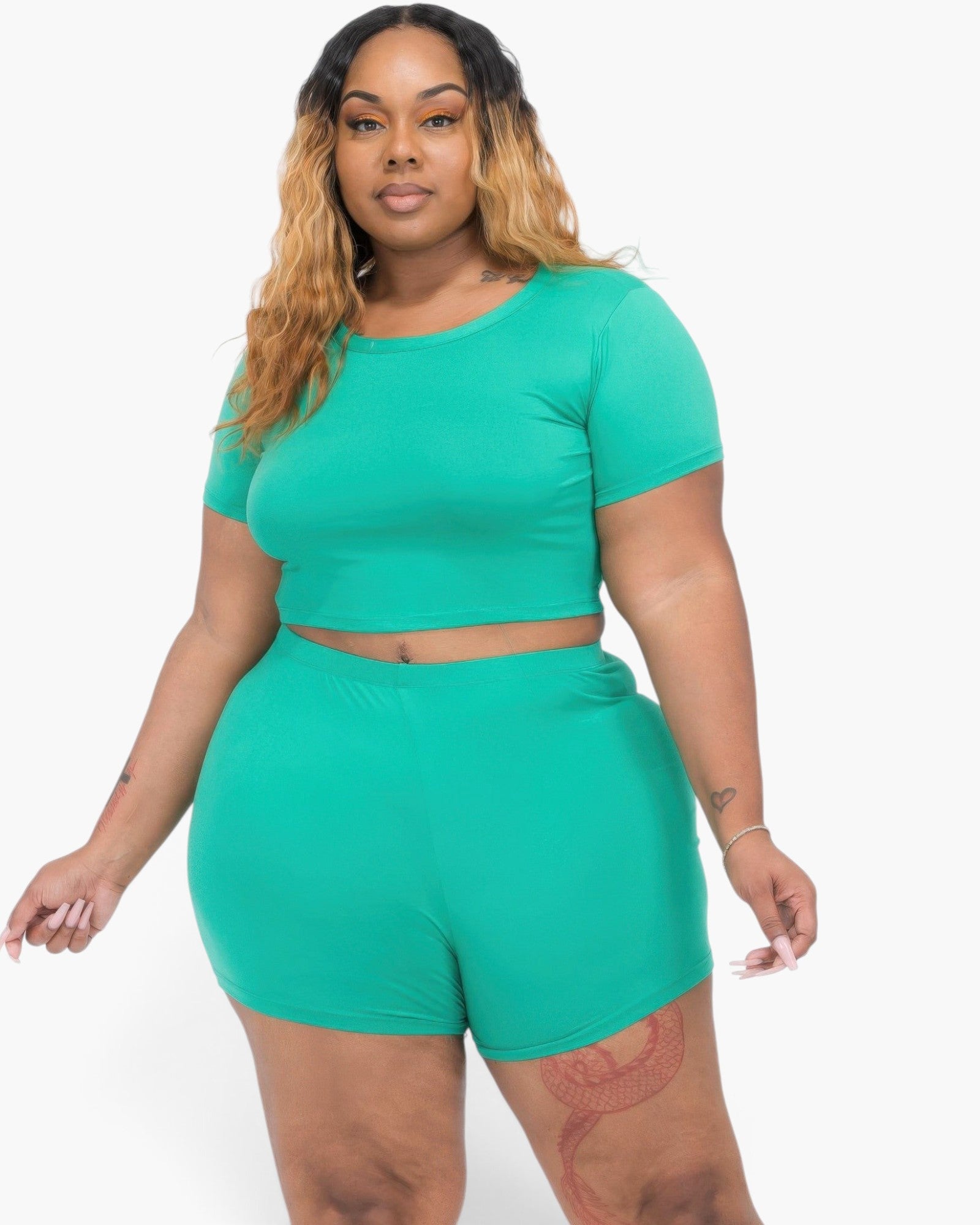 Beach Rose Co. plus size model wearing a vibrant green short sleeve crop top and matching shorts set in jersey fabric.