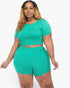 Beach Rose Co. plus size model wearing a vibrant green short sleeve crop top and matching shorts set in jersey fabric.