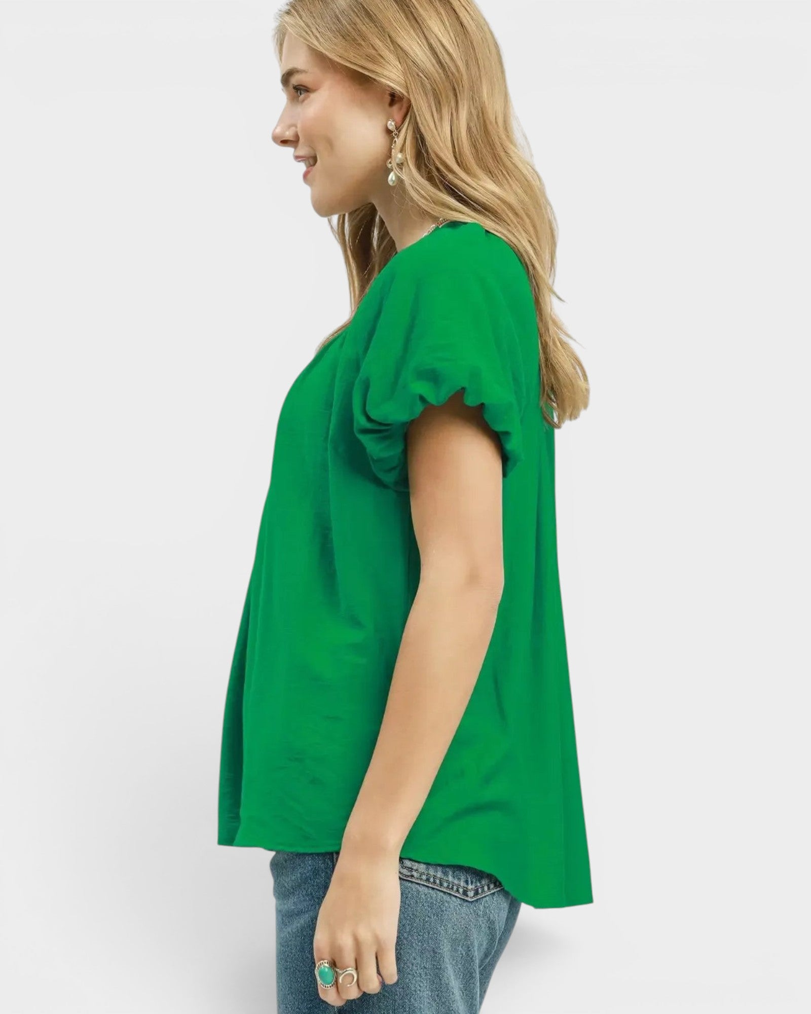 Beach Rose Co. green textured woven rayon-nylon blouse with puff sleeves and ruffled V-neckline.