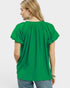 Beach Rose Co. green textured woven rayon-nylon blend blouse with ruffled V-neckline and puff sleeves.