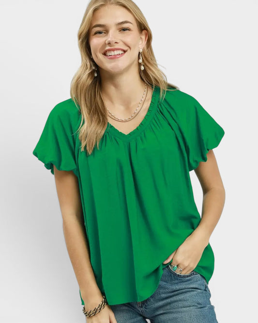 Beach Rose Co. green textured woven rayon-nylon blend blouse with ruffled V-neckline and puff sleeves.
