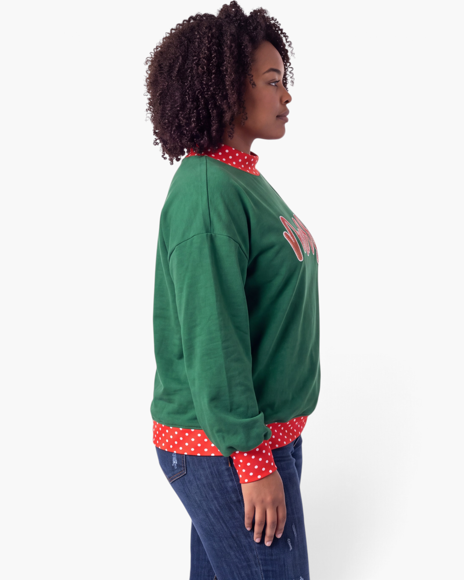 Beach Rose Co. green Christmas sweatshirt with red sequin merry text and polka dot trim worn by a model side view