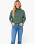 Beach Rose Co. green micro-stripe turtleneck top with dropped shoulders worn by a smiling blonde woman with blue jeans