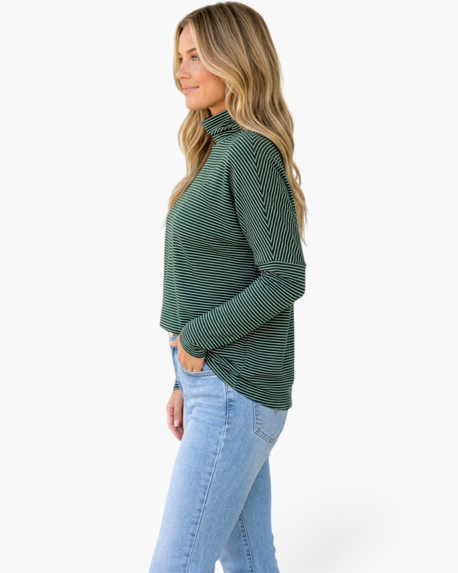 Beach Rose Co. green micro-stripe turtleneck top with dropped shoulders worn by a blonde model in profile view
