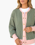 Beach Rose Co. green and white striped cardigan with a pink snap-front placket, neckline, and cuffs.
