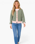 Beach Rose Co. green striped cardigan with pink trim, snap-front closure, and long sleeves worn with blue jeans.