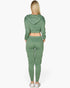 Beach Rose Co. green French terry cropped zip-up jacket and joggers set worn by a woman from the back view